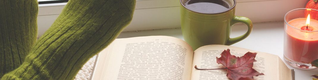 Cozy reading with a fall leaf and coffee
