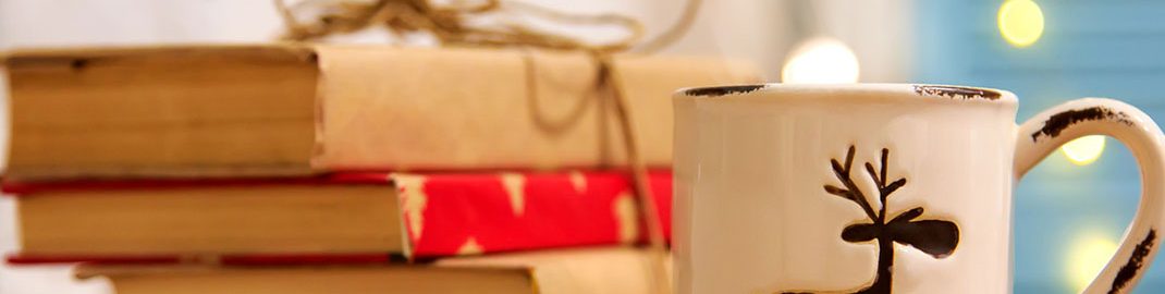 Stack of gift-wrapped books with a mug