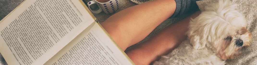 Reading in bed with puppy