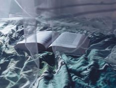 Open book on a bed