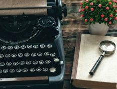 Typewriter with book and flowers