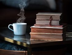 Hot drink and a stack of old books